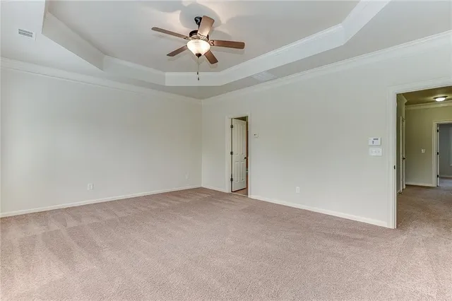 an empty room with a ceiling fan and a chandelier fan