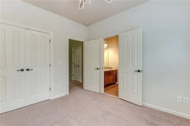 a view of an empty room with closet area