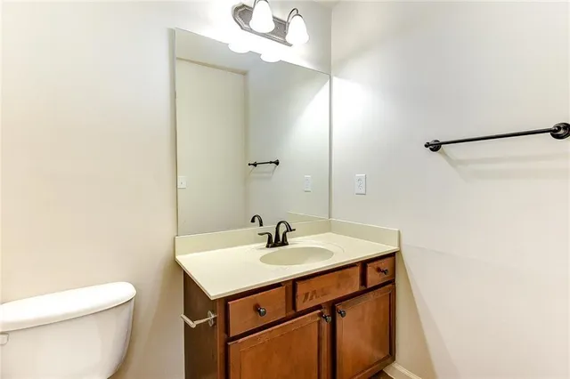 a bathroom with a sink a toilet and mirror