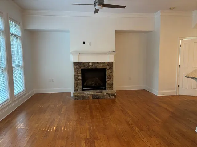 a view of an empty room with a fireplace and a window