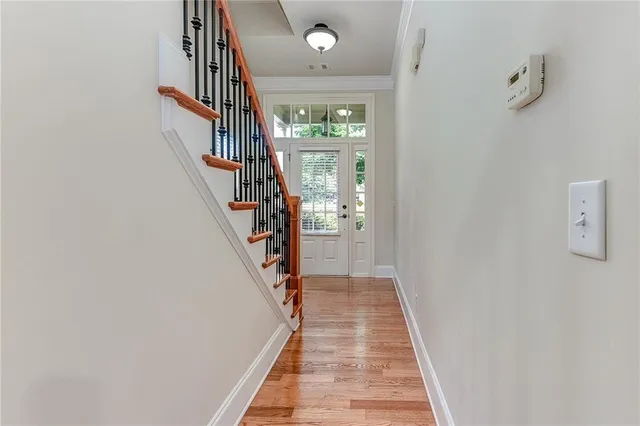 a view of a hallway with wooden floor and entryway
