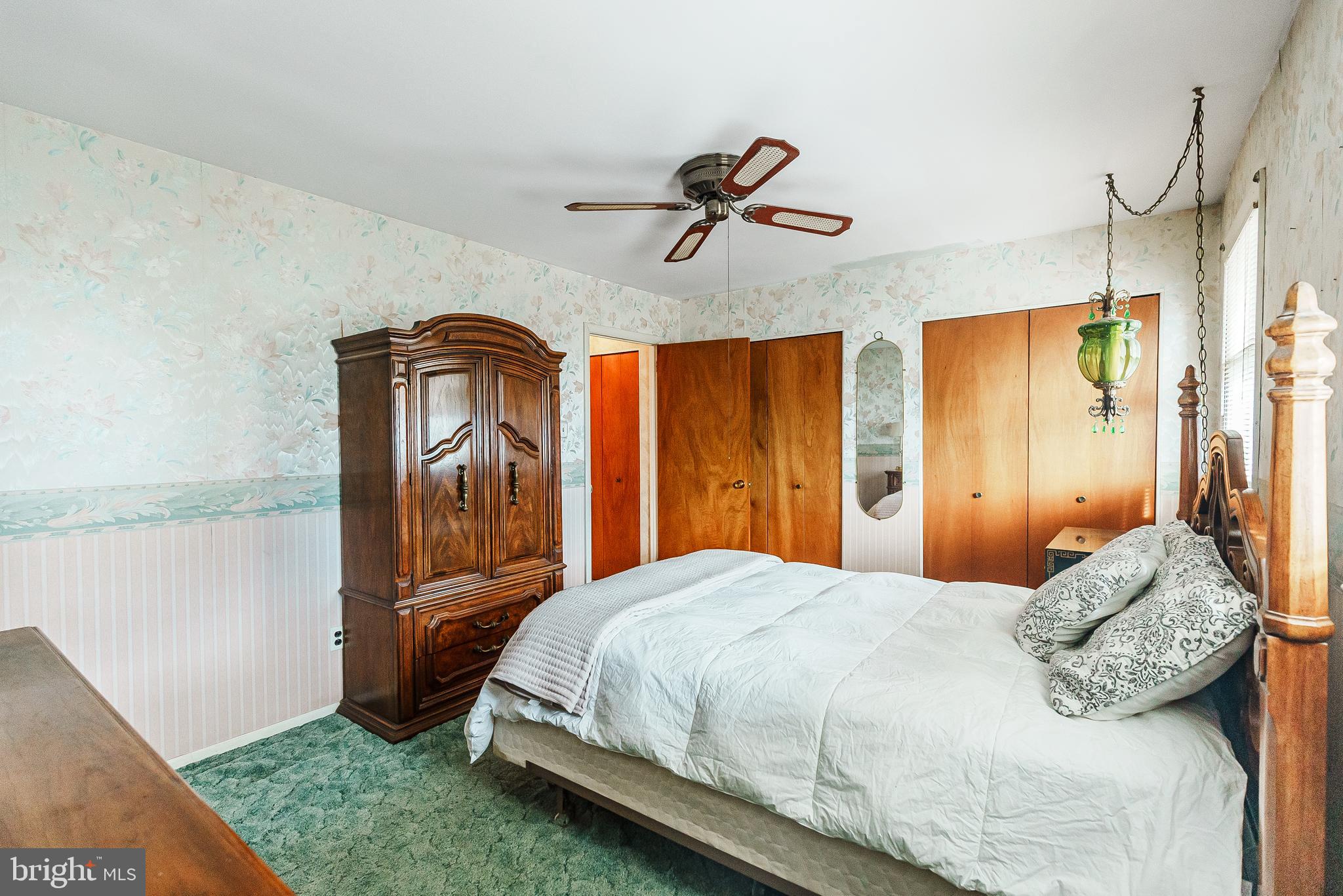 9229 Cottage Street Philadelphia, PA 19114 - Photo 7 of 14 a bedroom with a bed a dresser and mirror