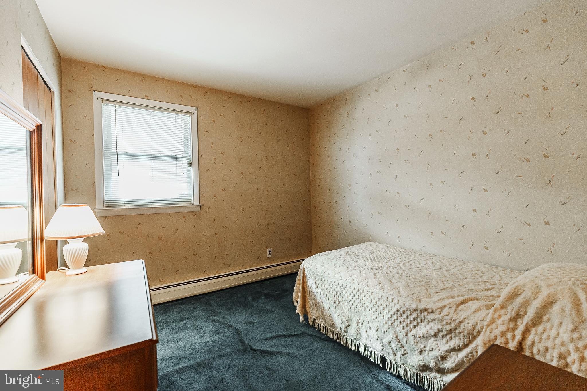 9229 Cottage Street Philadelphia, PA 19114 - Photo 8 of 14 a bedroom with a bed and a window