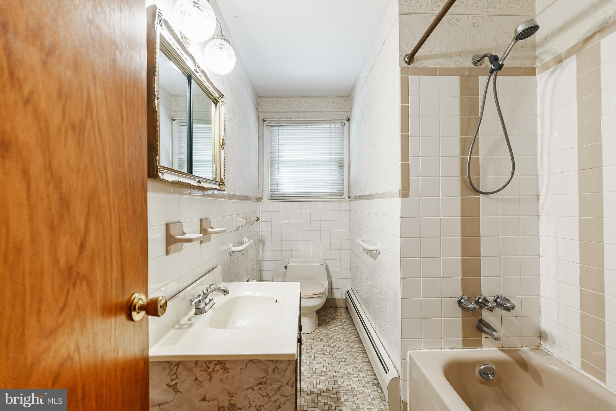 9229 Cottage Street Philadelphia, PA 19114 - Photo 10 of 14 a bathroom with a sink a granite counter and a bathtub