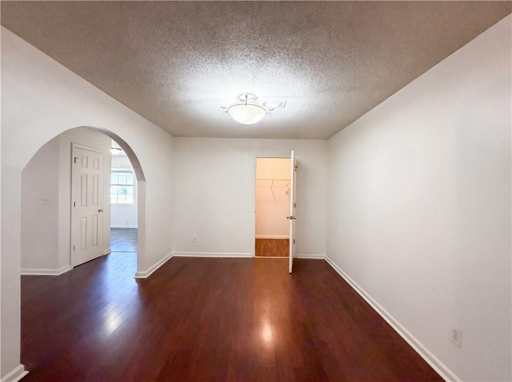 3753 Soapstone Road Decatur, GA 30034 - Photo 7 of 26 an empty room with wooden floor and windows