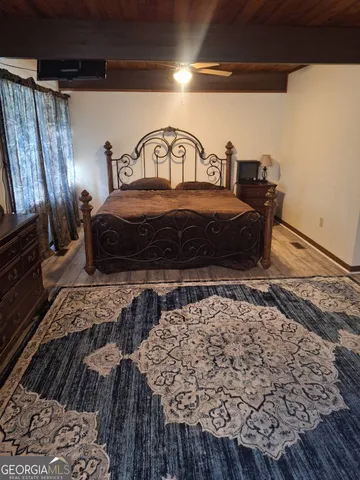 a bedroom with a bed and a dresser