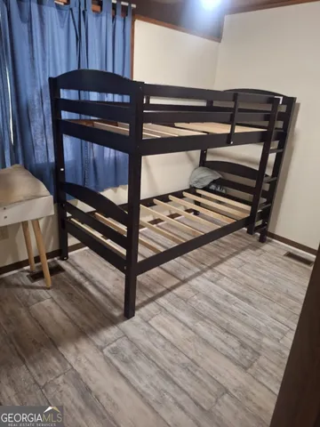 a room with wooden floor and furniture