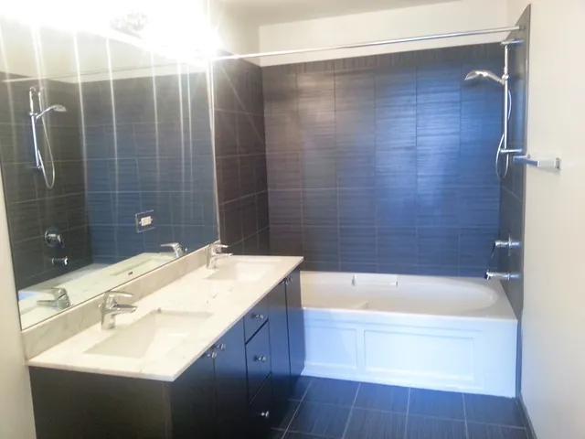 a bathroom with a sink mirror and shower