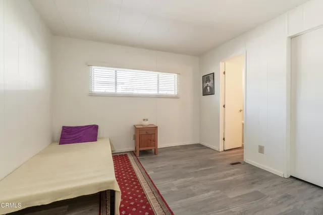 a bedroom with a bed and a dresser in it