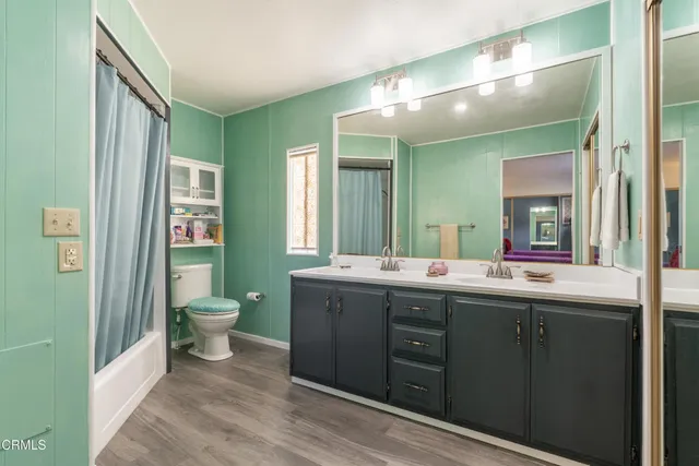 a spacious bathroom with a granite countertop sink mirror and toilet