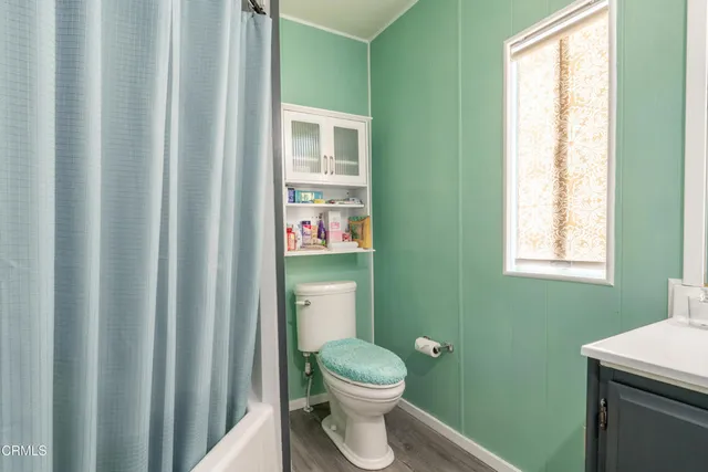 a bathroom with a toilet a sink and a window