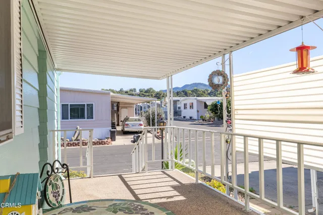 a room with stainless steel appliances kitchen island granite countertop a sink and cabinets