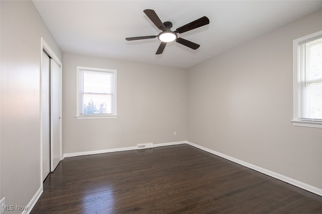 4631 Belfiore Road Cleveland, OH 44128 - Photo 16 of 28 bedroom with dark wood-style flooring, a closet, ceiling fan, and multiple windows