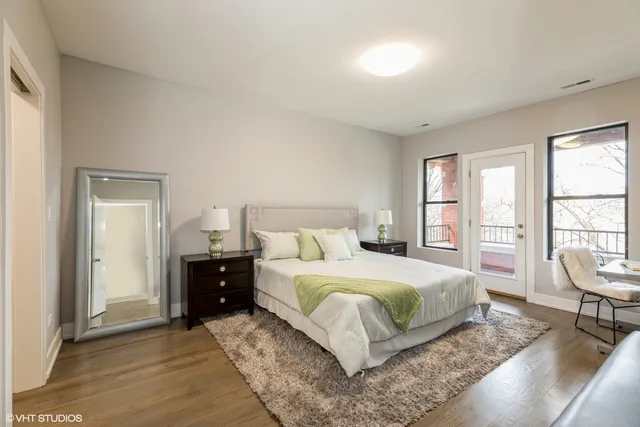 a bedroom with a bed a table and chair