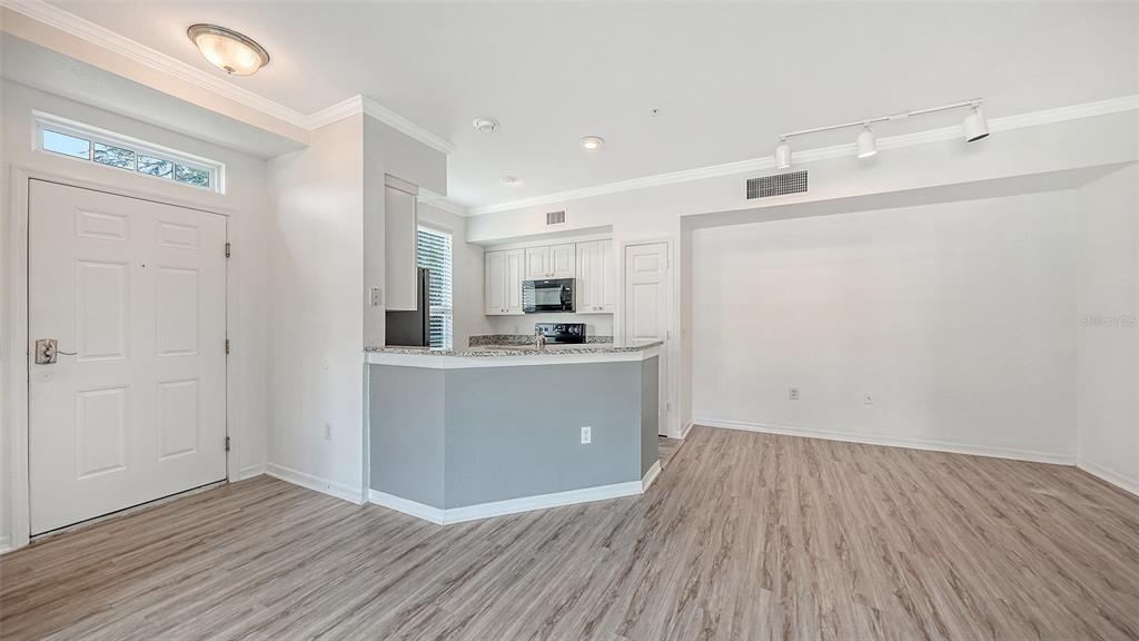 5501 Rosehill Road, Unit 105 Sarasota, FL 34233 - Photo 12 of 45 a room with a white wooden cabinets and white appliances