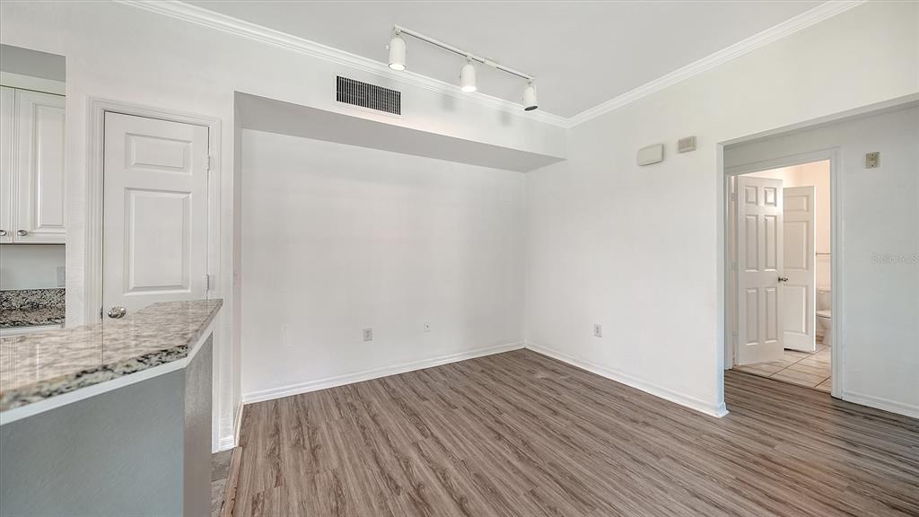 5501 Rosehill Road, Unit 105 Sarasota, FL 34233 - Photo 13 of 45 a view of a kitchen with wooden floor and a sink
