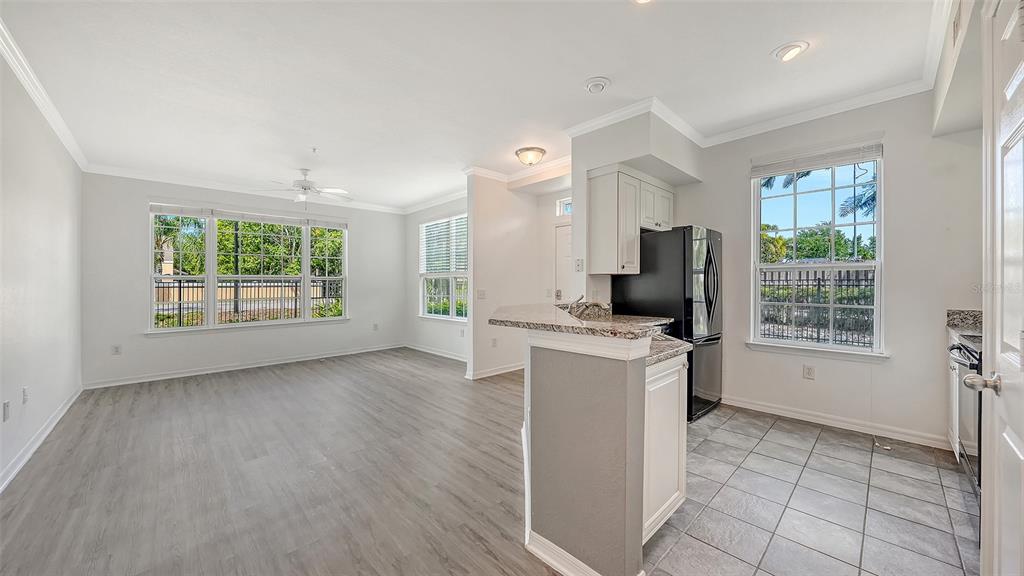 5501 Rosehill Road, Unit 105 Sarasota, FL 34233 - Photo 14 of 45 a view of a kitchen with furniture and a window