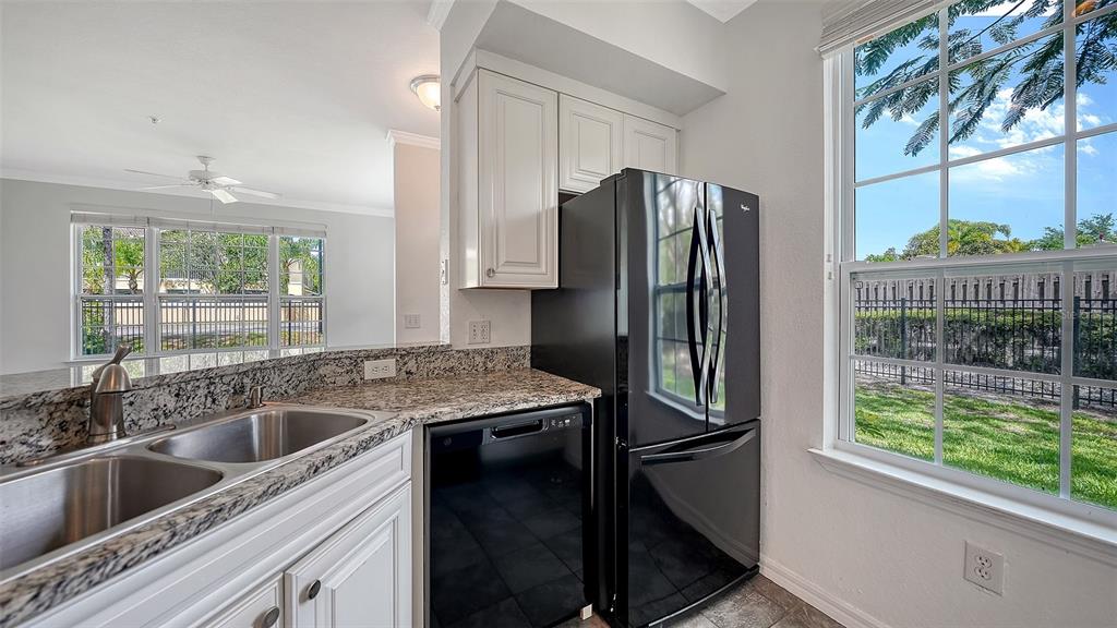 5501 Rosehill Road, Unit 105 Sarasota, FL 34233 - Photo 18 of 45 a kitchen with a refrigerator and a sink