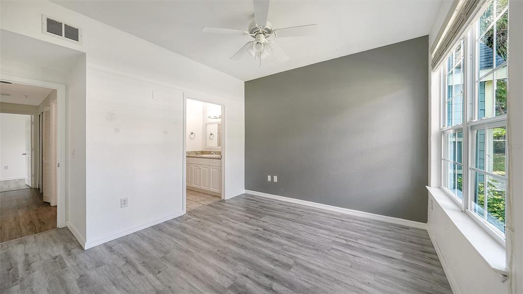 5501 Rosehill Road, Unit 105 Sarasota, FL 34233 - Photo 20 of 45 a view of an empty room with window and wooden floor