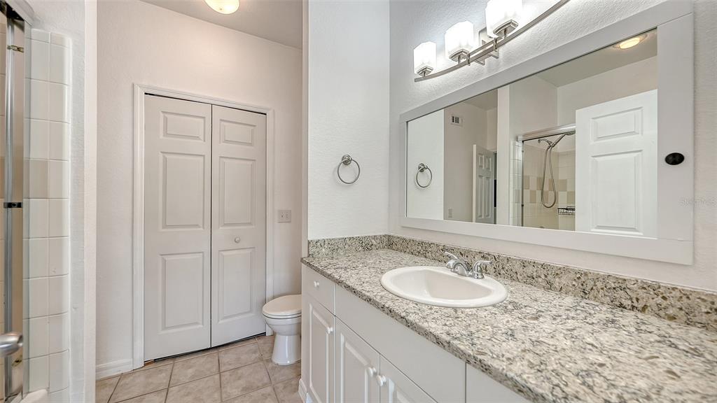 5501 Rosehill Road, Unit 105 Sarasota, FL 34233 - Photo 23 of 45 a bathroom with a granite countertop sink and a mirror
