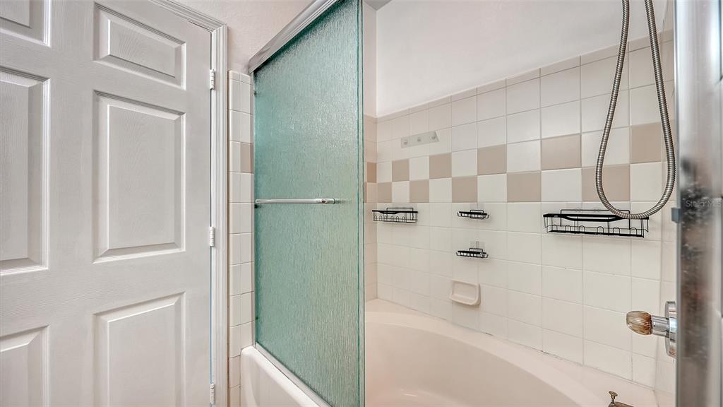 5501 Rosehill Road, Unit 105 Sarasota, FL 34233 - Photo 24 of 45 a bathroom with a bathtub and a shower