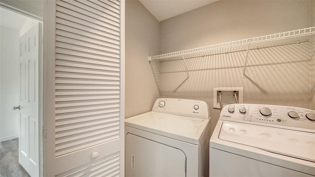 5501 Rosehill Road, Unit 105 Sarasota, FL 34233 - Photo 26 of 45 a utility room with dryer and washer