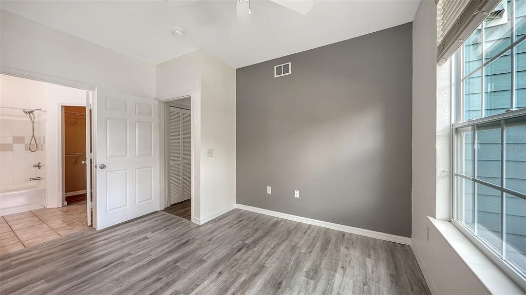 5501 Rosehill Road, Unit 105 Sarasota, FL 34233 - Photo 29 of 45 wooden floor and windows in an empty room