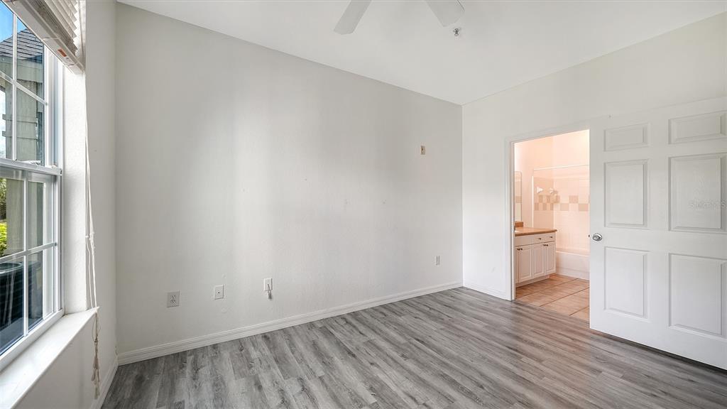5501 Rosehill Road, Unit 105 Sarasota, FL 34233 - Photo 30 of 45 a view of empty room with wooden floor and fan