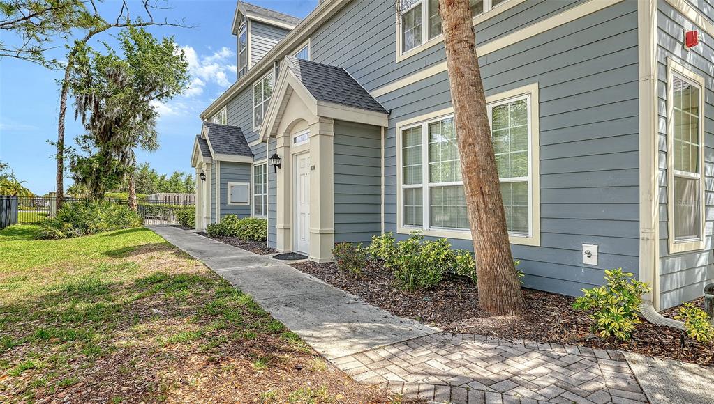 5501 Rosehill Road, Unit 105 Sarasota, FL 34233 - Photo 5 of 45 a front view of a house with garden