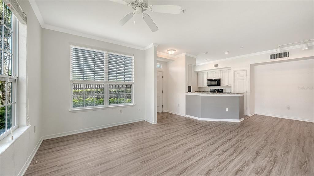 5501 Rosehill Road, Unit 105 Sarasota, FL 34233 - Photo 9 of 45 a view of kitchen with wooden floor electronic appliances and window