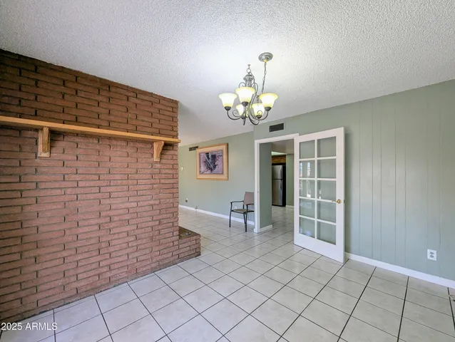a kitchen with granite countertop a refrigerator and a stove top oven