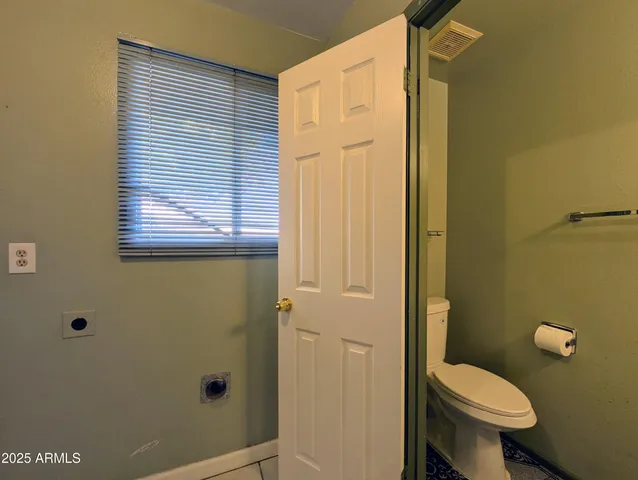 a view of room with wooden floor and ceiling fan