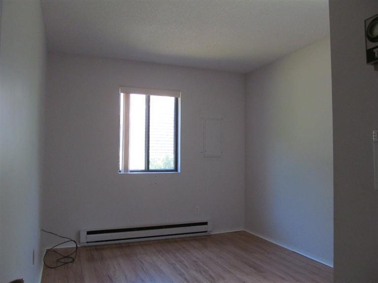65 Round House Road, Unit 65 Bourne, MA 02532 - Photo 11 of 18 an empty room with wooden floor and windows