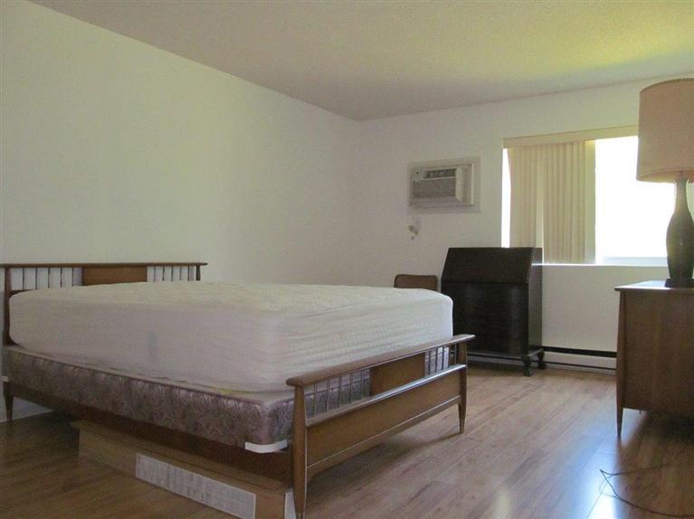 65 Round House Road, Unit 65 Bourne, MA 02532 - Photo 7 of 18 a bed sitting in a bedroom next to a window