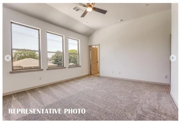 a view of a kitchen with a sink and a refrigerator
