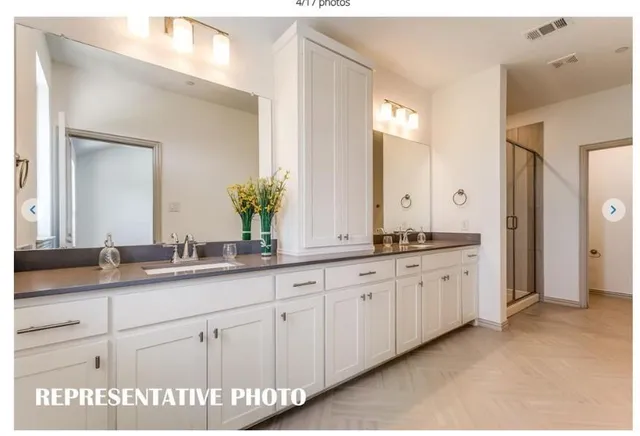 a large white kitchen with kitchen island a sink dishwasher a stove and a refrigerator with wooden floor