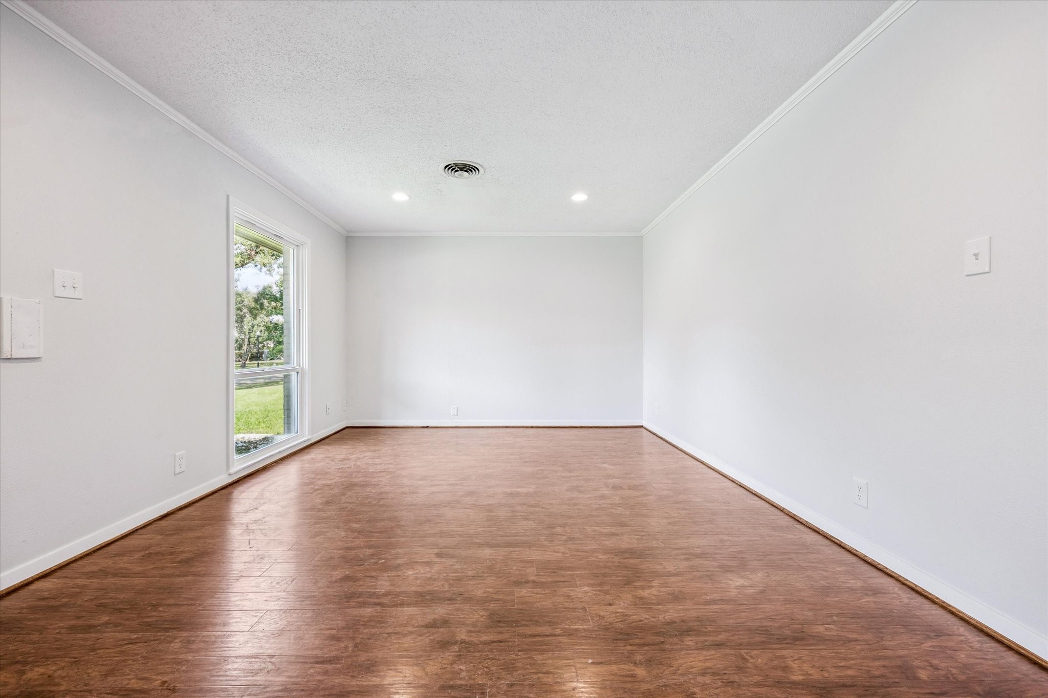 3607 Blue Bonnet Boulevard Houston, TX 77025 - Photo 11 of 14 a view of an empty room with wooden floor and window