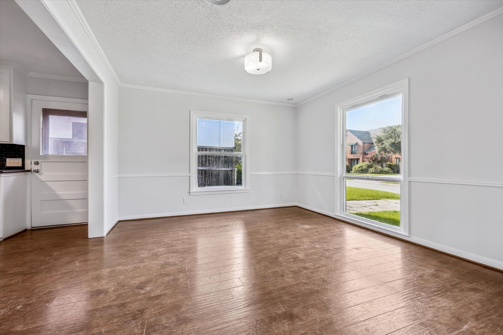 3607 Blue Bonnet Boulevard Houston, TX 77025 - Photo 2 of 14 a view of an empty room with a window and wooden floor