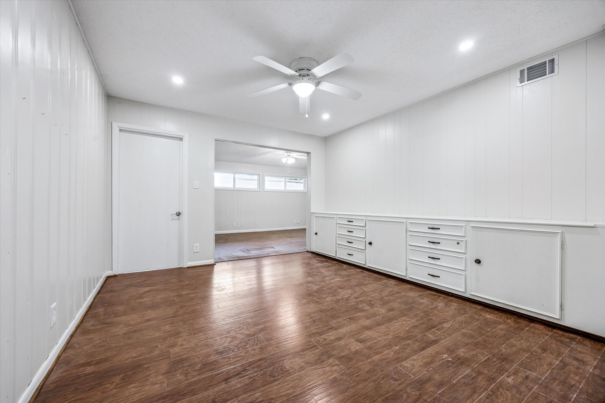 3607 Blue Bonnet Boulevard Houston, TX 77025 - Photo 7 of 14 an empty room with wooden floor and windows