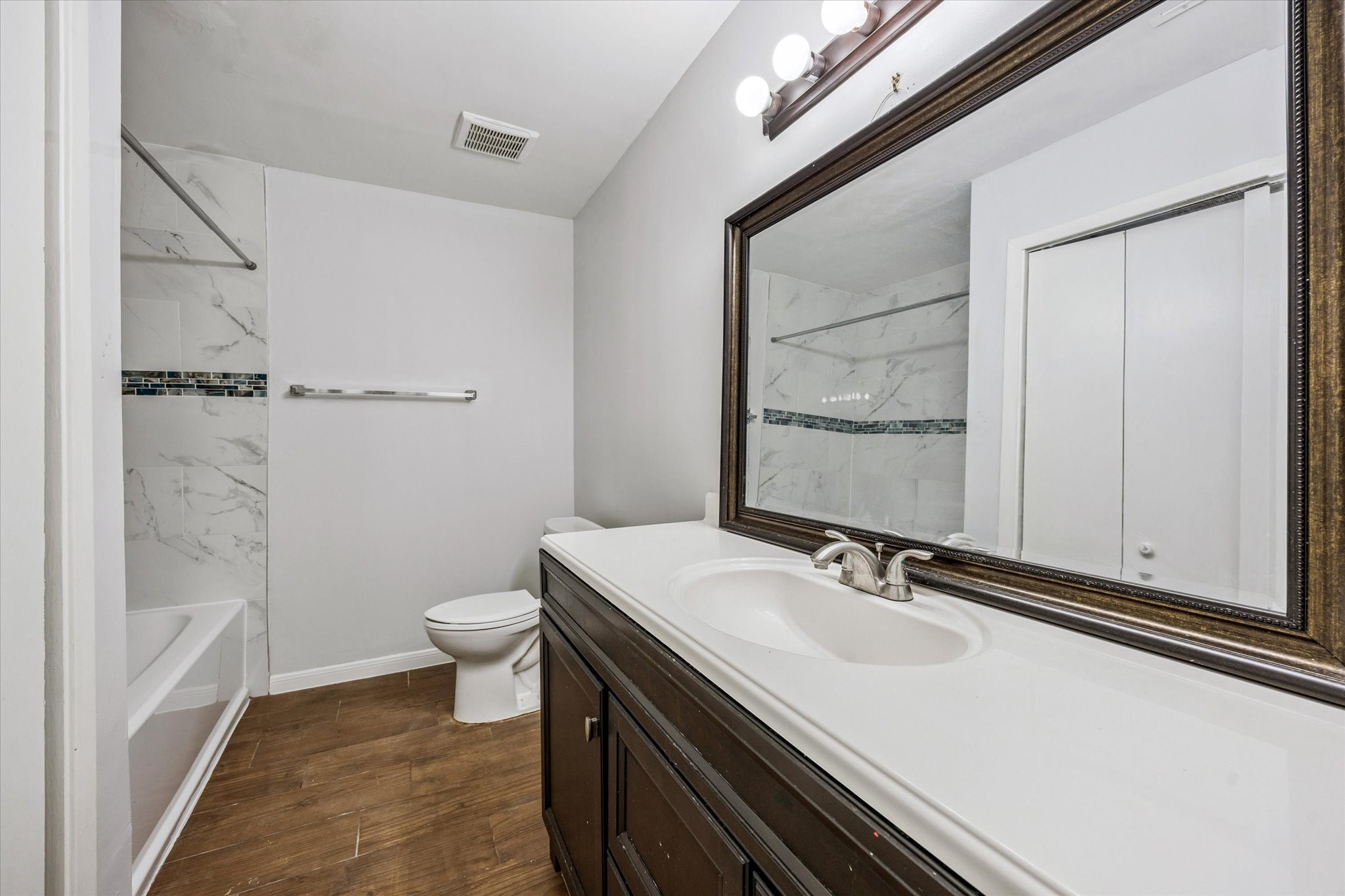 3607 Blue Bonnet Boulevard Houston, TX 77025 - Photo 8 of 14 a bathroom with a sink a toilet and shower