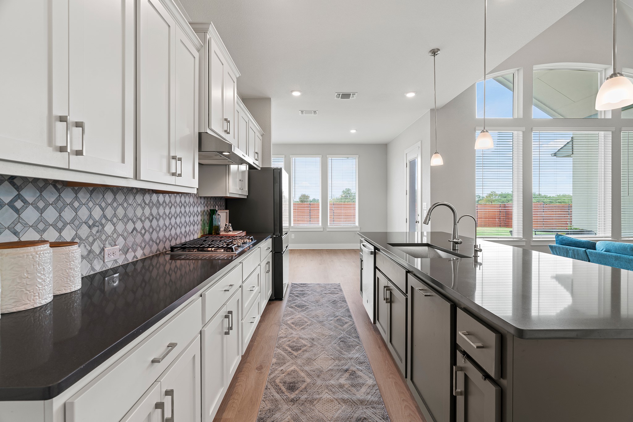 2112 Tobiano Trace Georgetown, TX 78633 - Photo 13 of 40 Kitchen featuring light wood-style floors, white cabinetry, hanging light fixtures, and recessed lighting