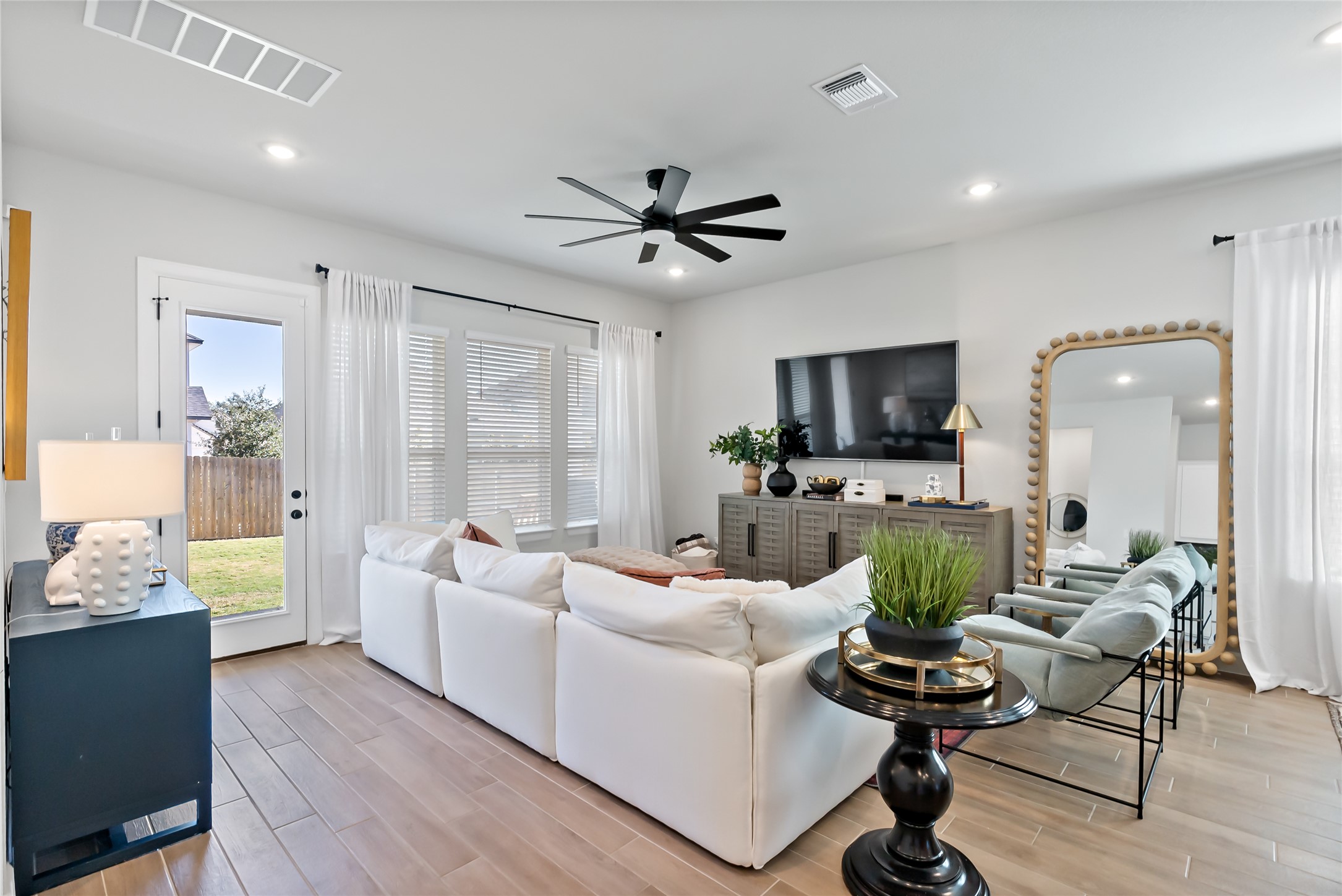 163 Cotton Tree Terrace Dripping Springs, TX 78620 - Photo 14 of 30 a living room with furniture a flat screen tv and a large window
