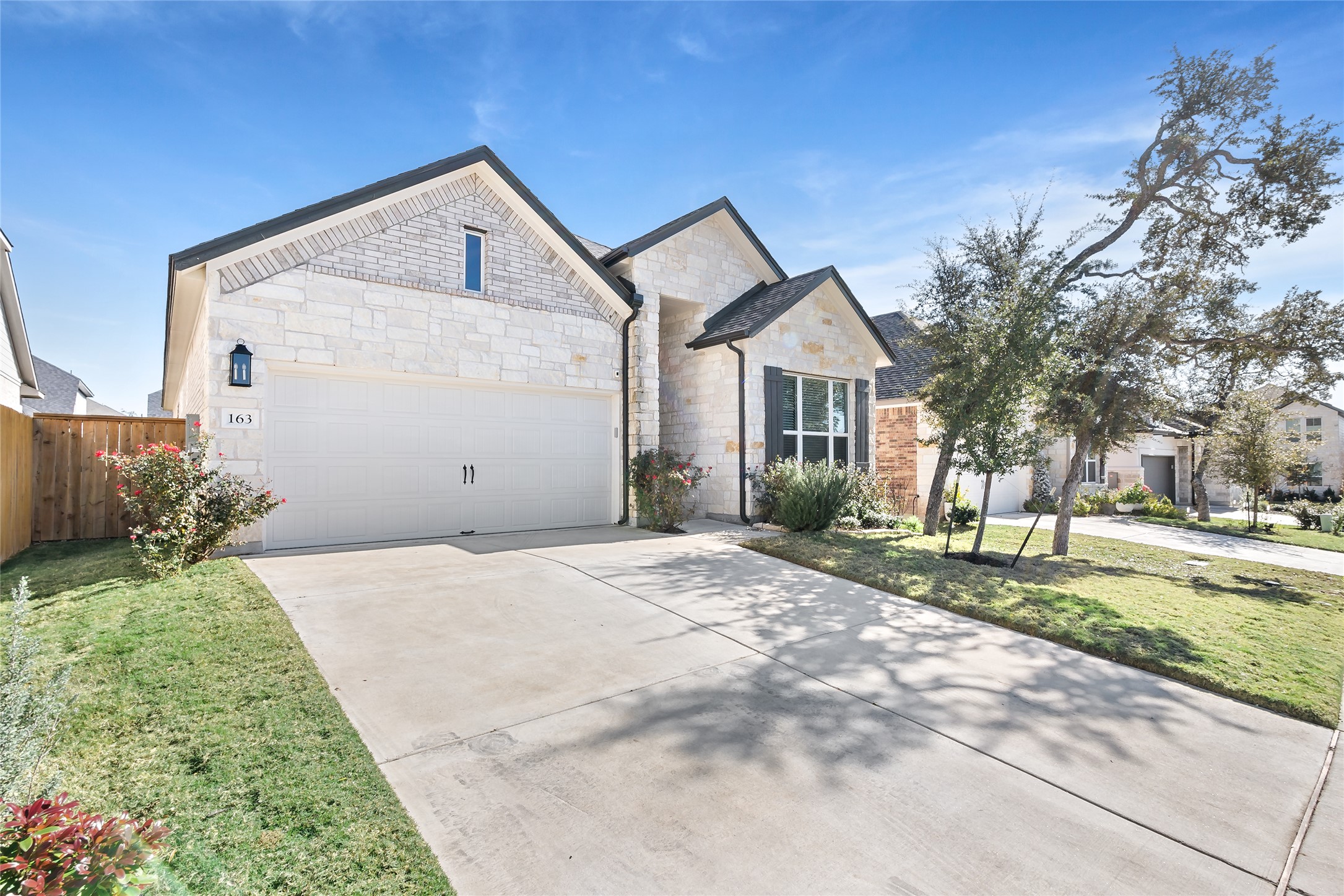 163 Cotton Tree Terrace Dripping Springs, TX 78620 - Photo 2 of 30 a front view of a house with a yard and garage