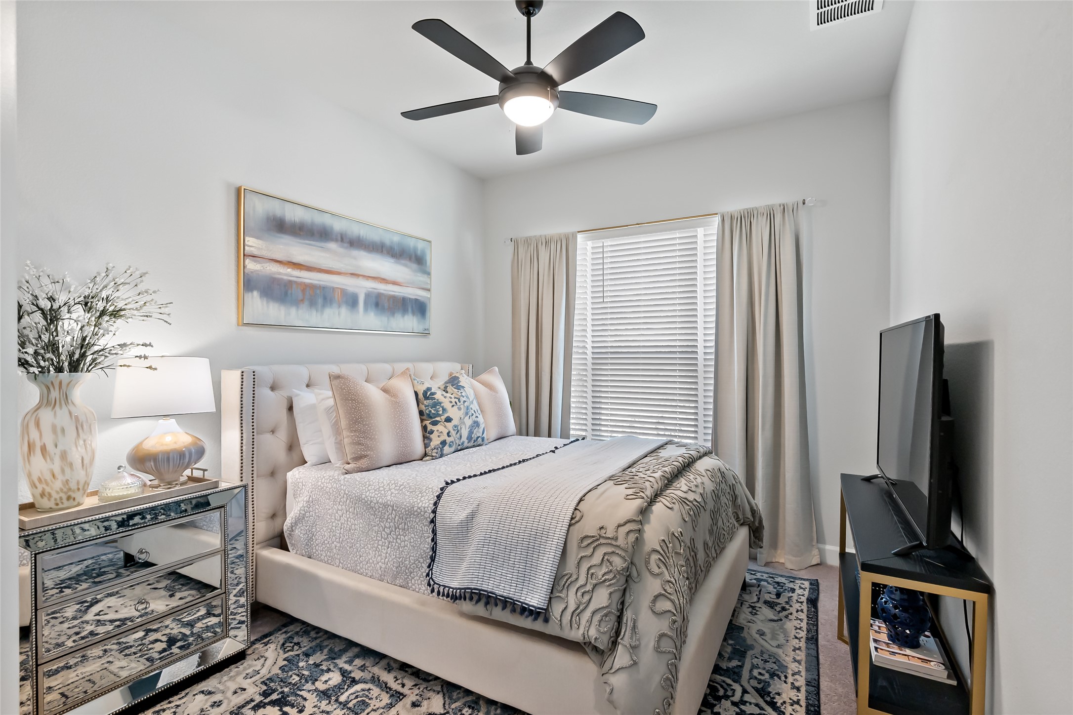 163 Cotton Tree Terrace Dripping Springs, TX 78620 - Photo 24 of 30 a bedroom with a bed and a flat screen tv