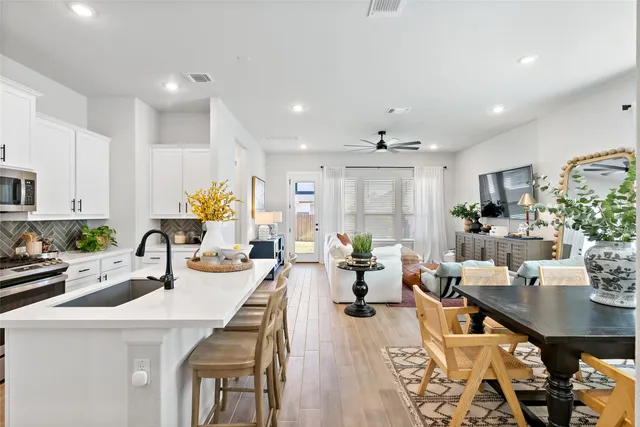 a large kitchen with a table and chairs