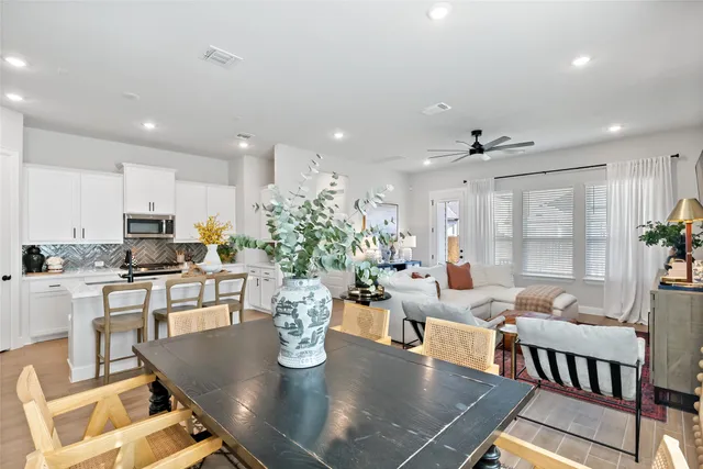 a living room with dining room and wooden floor