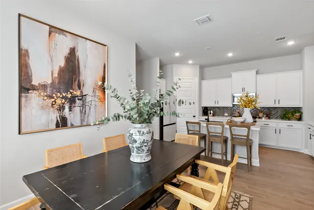a view of a dining room with furniture and wooden floor