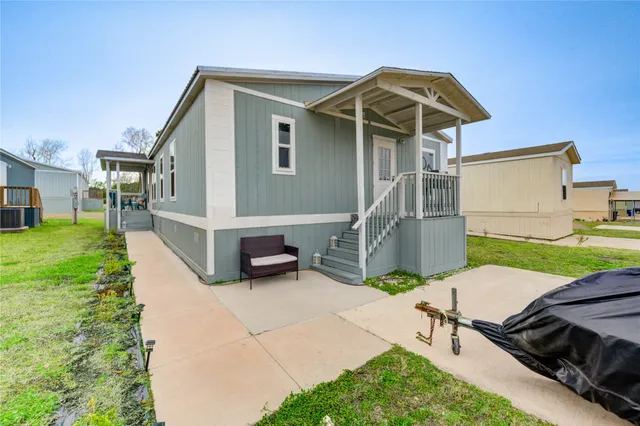 a view of a house with backyard and sitting area