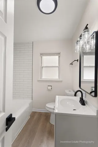 a bathroom with a sink a toilet and a bathtub