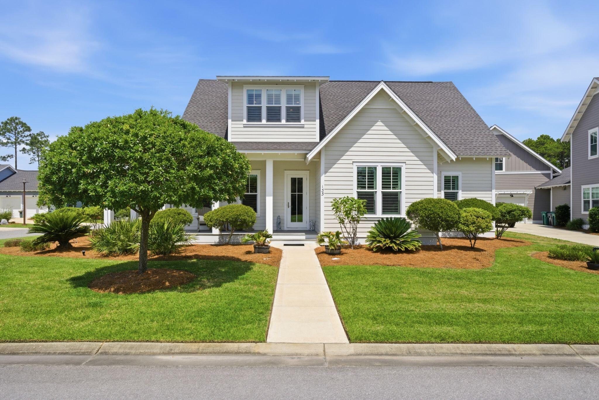 133 Sandchase Circle, Unit LOT 15 Inlet Beach, FL 32461 - Photo 1 of 47 a front view of a house with a yard and potted plants